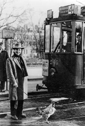 Tram streetca in the 40's in Holland and a man out for a walk with his rooster